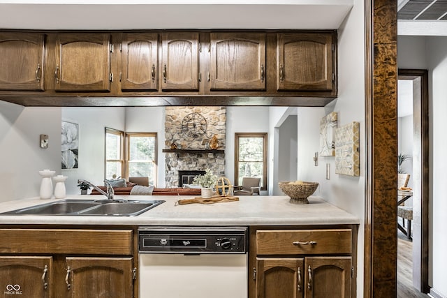 2247 Frisco Pl, Indianapolis, IN 46240 - kitchen with dishwasher, light countertops, a fireplace, dark brown cabinets, and open floor plan