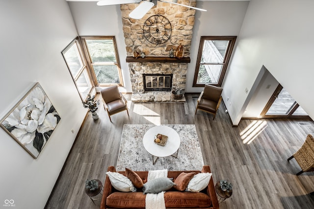2247 Frisco Pl, Indianapolis, IN 46240 - living room with a stone fireplace, wood finished floors, a towering ceiling, and ceiling fan