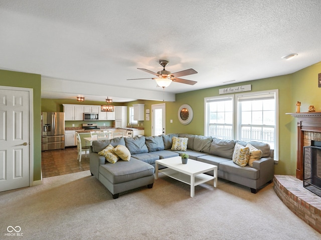 3075 W Crosscreek Dr, Monrovia, IN 46157 - living room featuring ceiling fan, light carpet, a brick fireplace, and a textured ceiling