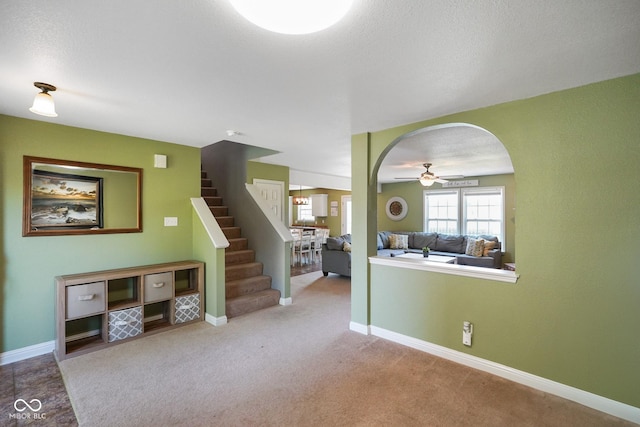 3075 W Crosscreek Dr, Monrovia, IN 46157 - living room with a ceiling fan, stairs, arched walkways, and carpet
