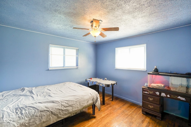 2911 N 200 W Rd, Franklin, IN 46131 - bedroom with multiple windows, wood finished floors, a textured ceiling, and ceiling fan