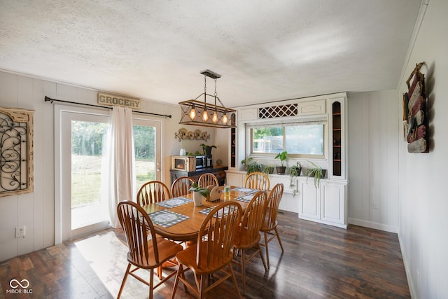 2911 N 200 W Rd, Franklin, IN 46131 - dining space with dark wood-style floors, healthy amount of natural light, a textured ceiling, a decorative wall, and a chandelier