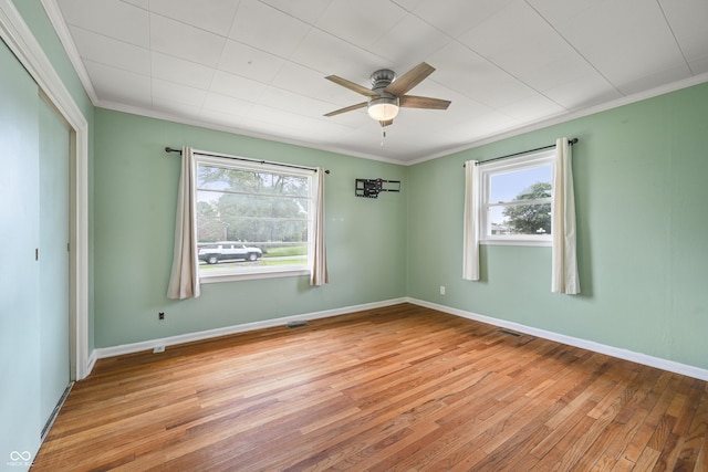 705 N Davidson St, Greensburg, IN 47240 - empty room with healthy amount of natural light, hardwood / wood-style floors, ceiling fan, and crown molding