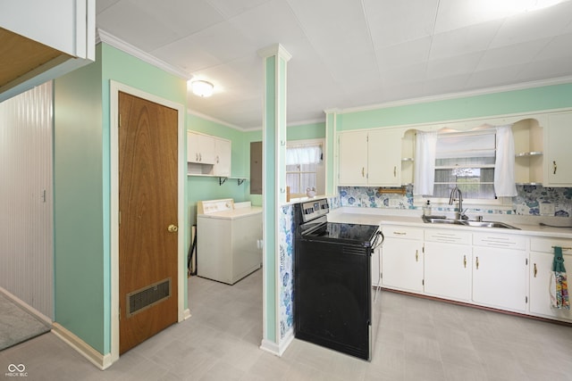 705 N Davidson St, Greensburg, IN 47240 - kitchen featuring black / electric stove, washing machine and clothes dryer, crown molding, light flooring, and light countertops
