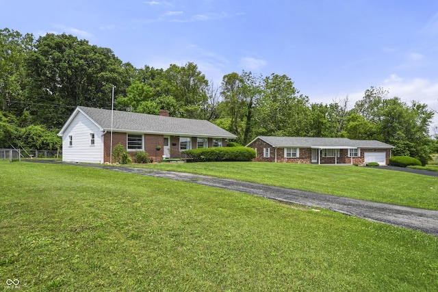 705 N Davidson St, Greensburg, IN 47240 - single story home with driveway, brick siding, a chimney, a garage, and view of scattered trees