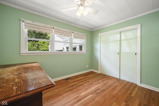 705 N Davidson St, Greensburg, IN 47240 - unfurnished bedroom featuring crown molding, hardwood / wood-style flooring, a closet, and ceiling fan