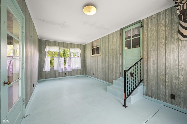 705 N Davidson St, Greensburg, IN 47240 - spare room featuring concrete floors, stairway, and wooden walls