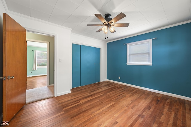 705 N Davidson St, Greensburg, IN 47240 - unfurnished bedroom with hardwood / wood-style floors, crown molding, a closet, and ceiling fan