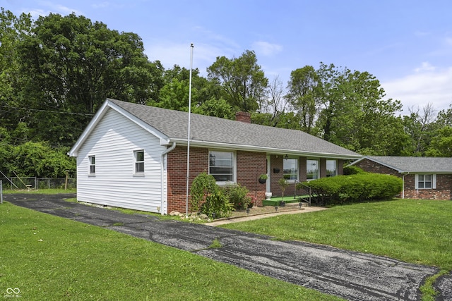 705 N Davidson St, Greensburg, IN 47240 - ranch-style home featuring a chimney, brick siding, and a shingled roof