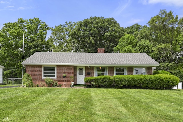 705 N Davidson St, Greensburg, IN 47240 - ranch-style house featuring brick siding, a front yard, a chimney, and a shingled roof