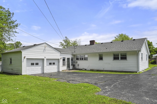 705 N Davidson St, Greensburg, IN 47240 - view of front facade with a chimney, an attached garage, a front yard, a shingled roof, and asphalt driveway