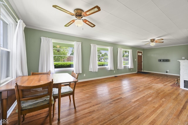 705 N Davidson St, Greensburg, IN 47240 - living room with ceiling fan, light wood-type flooring, a brick fireplace, and crown molding