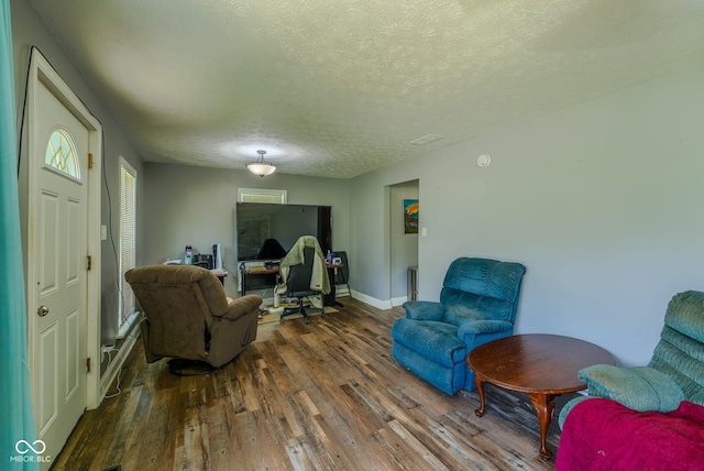 1905 W Brownstown Rd, North Vernon, IN 47265 - living area with wood finished floors, an office area, and a textured ceiling