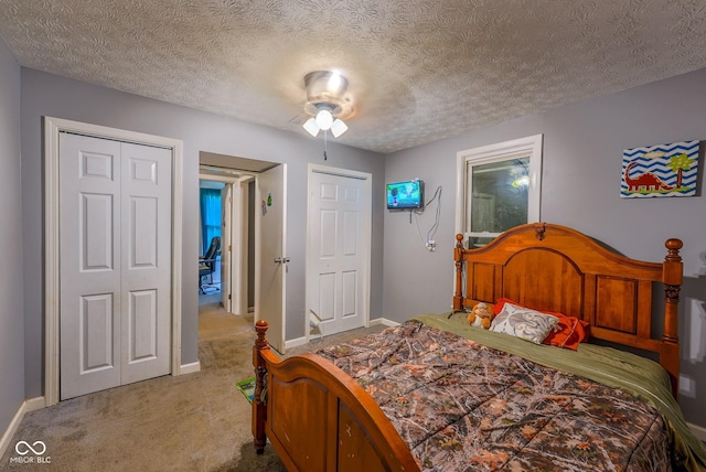 1905 W Brownstown Rd, North Vernon, IN 47265 - bedroom featuring carpet, a textured ceiling, and two closets