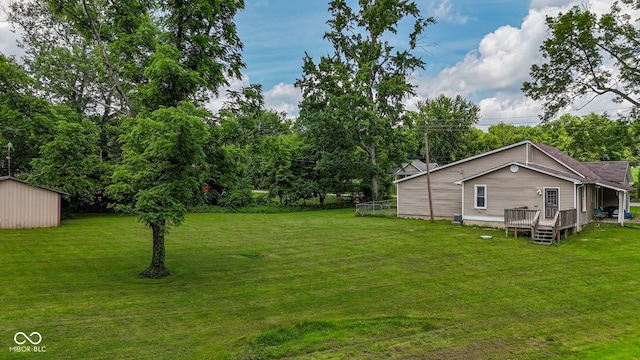 1905 W Brownstown Rd, North Vernon, IN 47265 - view of green lawn featuring a wooden deck and an outbuilding