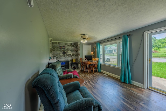 1905 W Brownstown Rd, North Vernon, IN 47265 - living room featuring wood finished floors, a fireplace, and a textured ceiling