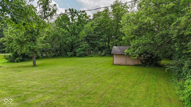 1905 W Brownstown Rd, North Vernon, IN 47265 - view of green lawn featuring a storage shed and a wooded view