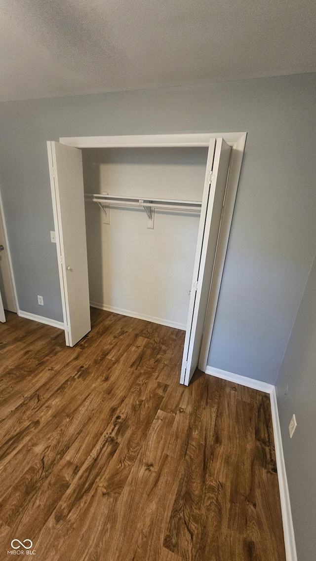 4614 Runyon Lake Dr W, Greenwood, IN 46143 - unfurnished bedroom with wood finished floors and a closet