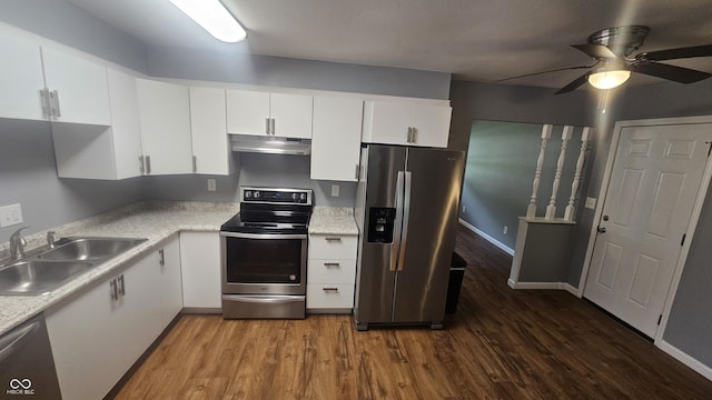 4614 Runyon Lake Dr W, Greenwood, IN 46143 - kitchen with appliances with stainless steel finishes, under cabinet range hood, dark wood finished floors, ceiling fan, and white cabinetry