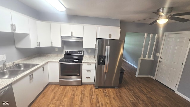 4614 Runyon Lake Dr W, Greenwood, IN 46143 - kitchen featuring appliances with stainless steel finishes, under cabinet range hood, wood finished floors, white cabinetry, and light countertops