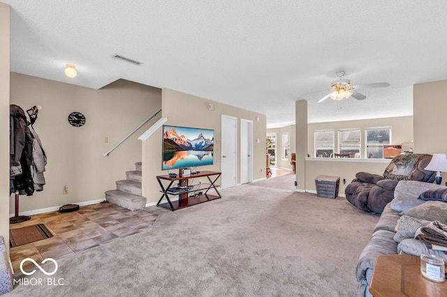 2309 Westmere Dr, Plainfield, IN 46168 - living room with stairs, ceiling fan, carpet floors, and a textured ceiling