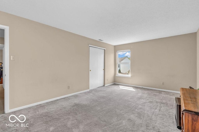2309 Westmere Dr, Plainfield, IN 46168 - unfurnished bedroom featuring carpet, a textured ceiling, and a closet