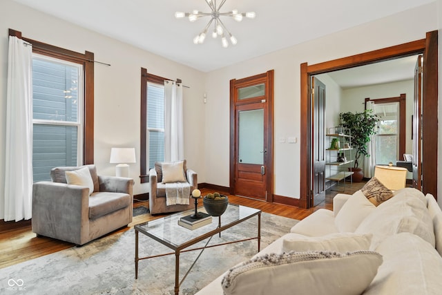 2026 E 10th St, Indianapolis, IN 46201 - living room featuring wood finished floors, plenty of natural light, and a chandelier