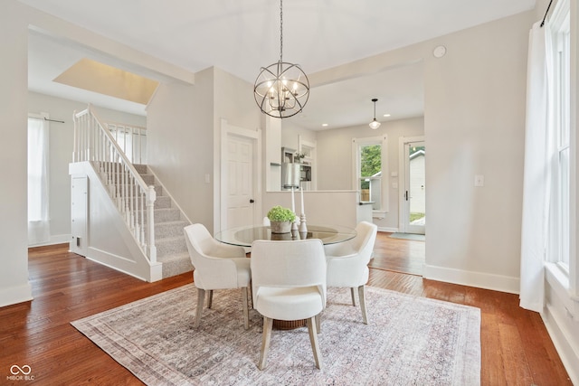 2026 E 10th St, Indianapolis, IN 46201 - dining area featuring stairs, wood finished floors, and a chandelier