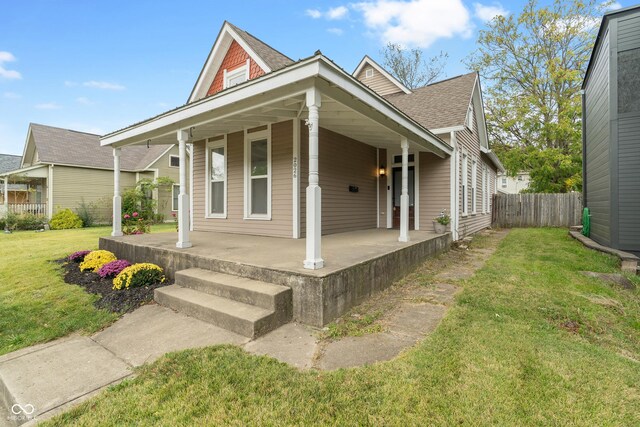 2026 E 10th St, Indianapolis, IN 46201 - view of front of home with covered porch and roof with shingles