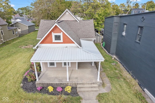 2026 E 10th St, Indianapolis, IN 46201 - back of house with a yard, a shingled roof, and a patio