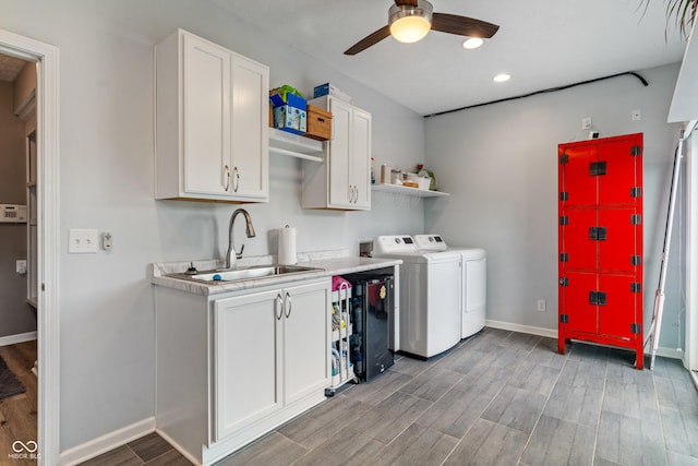8754 Lily Ct, Zionsville, IN 46077 - laundry area featuring washing machine and clothes dryer, ceiling fan, cabinet space, light wood-style floors, and recessed lighting