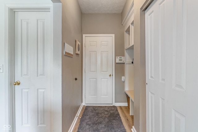 8754 Lily Ct, Zionsville, IN 46077 - mudroom with a textured ceiling and light wood-style flooring
