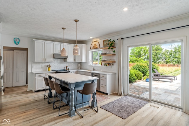 8754 Lily Ct, Zionsville, IN 46077 - kitchen featuring a breakfast bar area, light countertops, open shelves, a textured ceiling, and stainless steel dishwasher