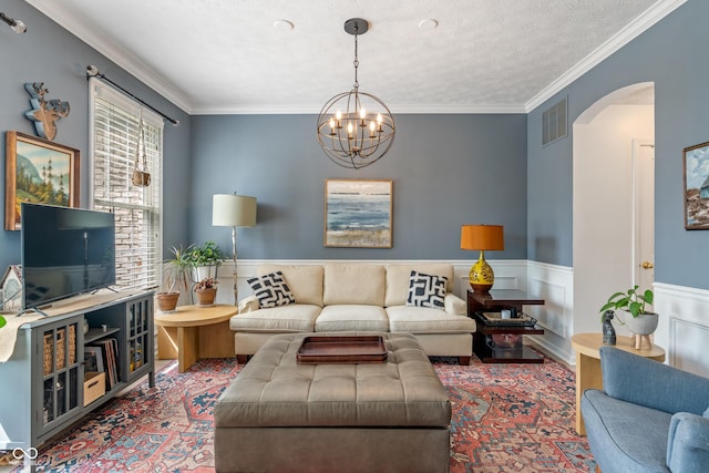 8754 Lily Ct, Zionsville, IN 46077 - living area featuring arched walkways, ornamental molding, a chandelier, wood finished floors, and a textured ceiling