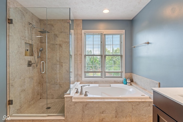8754 Lily Ct, Zionsville, IN 46077 - bathroom with a garden tub, healthy amount of natural light, a stall shower, vanity, and a textured ceiling