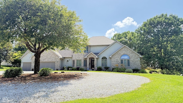 5586 S 200 E, Franklin, IN 46131 - traditional home featuring a front lawn, stone siding, driveway, and an attached garage