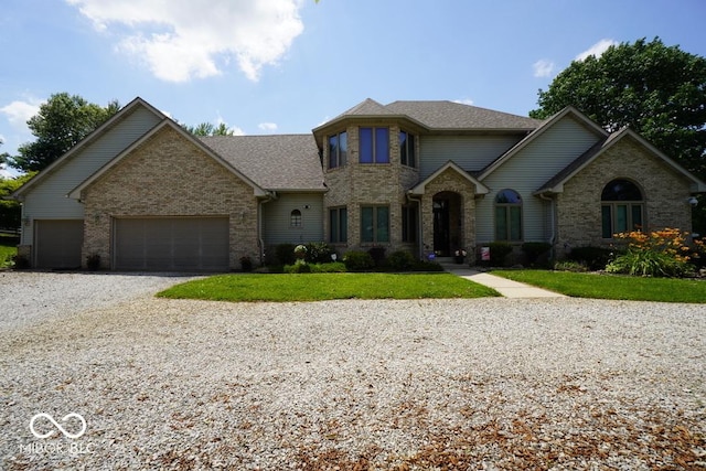 5586 S 200 E, Franklin, IN 46131 - view of front of house featuring driveway, a garage, brick siding, a front yard, and roof with shingles