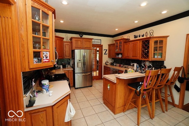 5586 S 200 E, Franklin, IN 46131 - kitchen with stainless steel appliances, a peninsula, backsplash, a kitchen breakfast bar, and recessed lighting