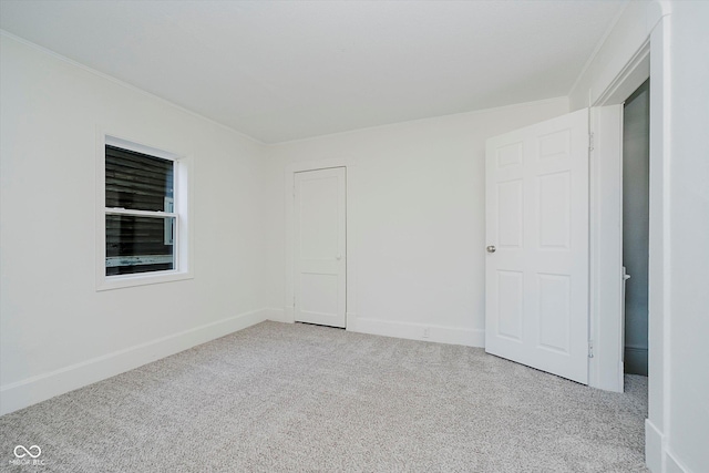 3709 Central Ave, Indianapolis, IN 46205 - unfurnished bedroom featuring carpet floors and crown molding