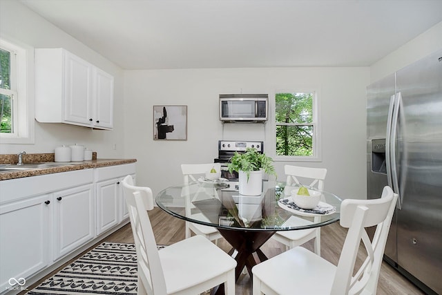 3709 Central Ave, Indianapolis, IN 46205 - dining space featuring light wood-type flooring and healthy amount of natural light