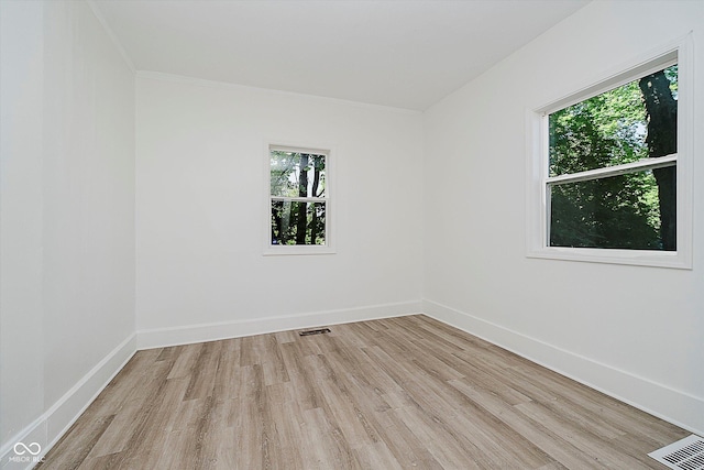 3709 Central Ave, Indianapolis, IN 46205 - empty room featuring plenty of natural light, light wood finished floors, and crown molding