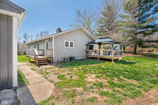 9267 N State Road 135, Morgantown, IN 46160 - back of property with a gazebo, a wooden deck, a yard, and a chimney