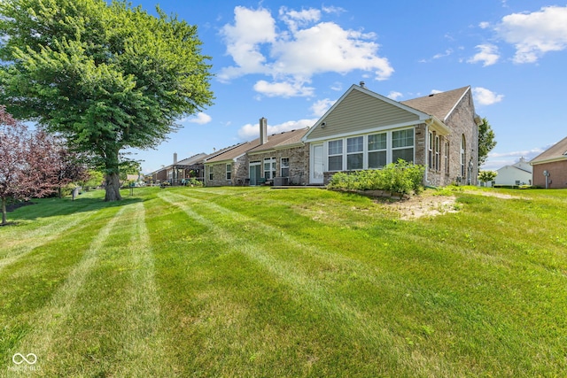7412 Lattice Dr, Indianapolis, IN 46217 - rear view of property featuring a lawn and stone siding