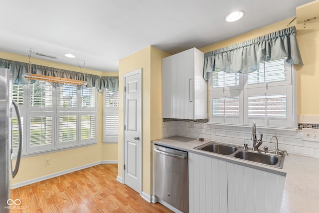 7412 Lattice Dr, Indianapolis, IN 46217 - kitchen featuring stainless steel appliances, light countertops, decorative backsplash, light wood-style floors, and recessed lighting