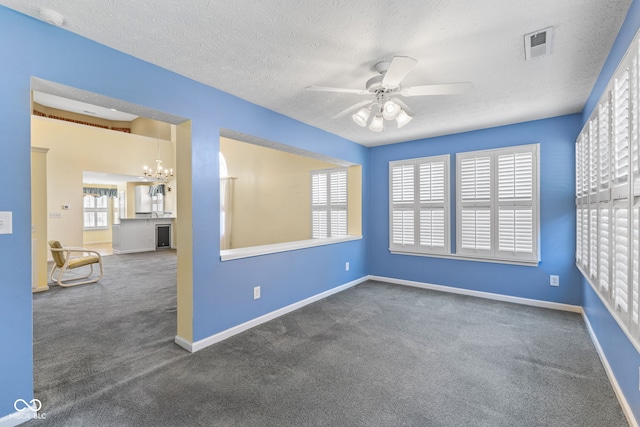 7412 Lattice Dr, Indianapolis, IN 46217 - carpeted spare room featuring ceiling fan, a textured ceiling, and a chandelier