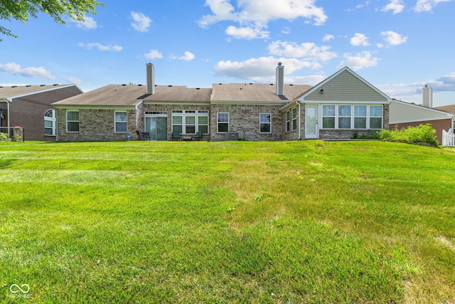 7412 Lattice Dr, Indianapolis, IN 46217 - back of property featuring a chimney, brick siding, and a yard