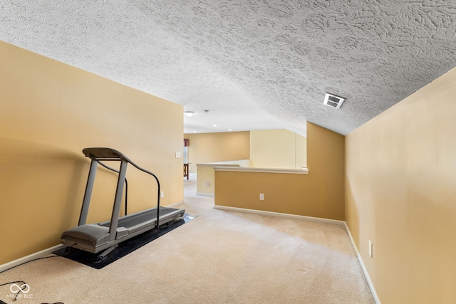 7412 Lattice Dr, Indianapolis, IN 46217 - exercise room with a textured ceiling, carpet flooring, and vaulted ceiling