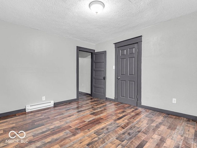 1126 N Rural St, Indianapolis, IN 46201 - spare room with a baseboard radiator, wood finished floors, and a textured ceiling