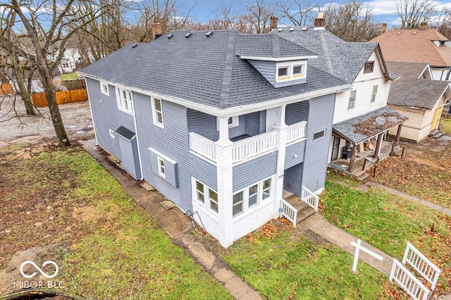 1126 N Rural St, Indianapolis, IN 46201 - rear view of property with roof with shingles, a balcony, and a chimney
