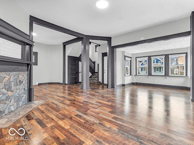 1126 N Rural St, Indianapolis, IN 46201 - unfurnished living room with wood finished floors and stairway